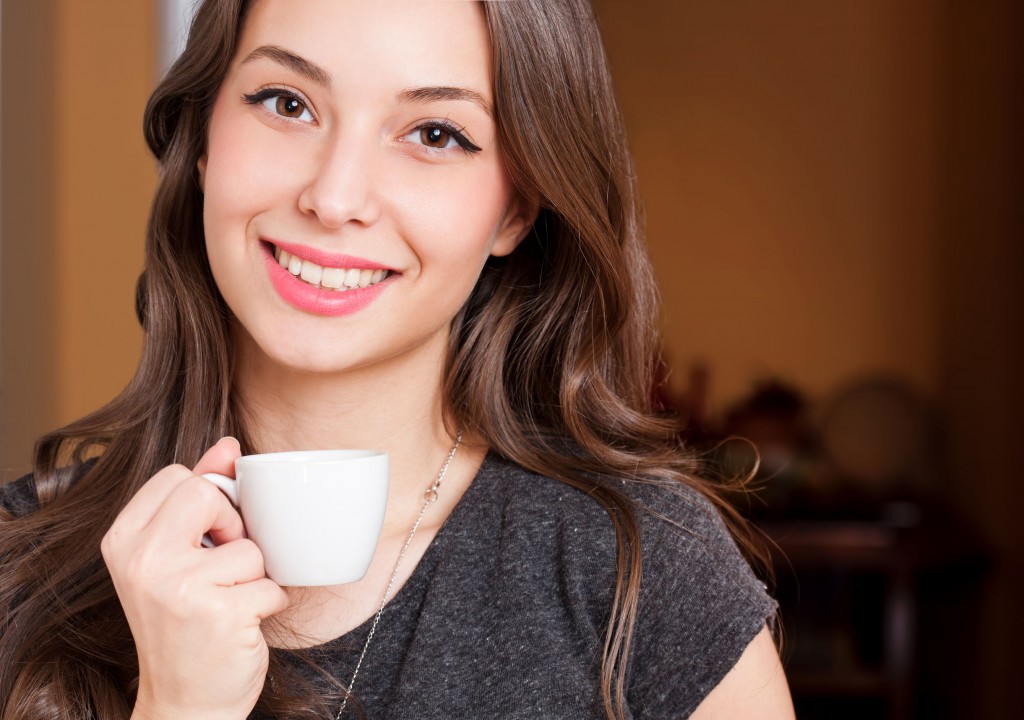 36175537 - portrait of a gorgeous young brunette woman having coffee.