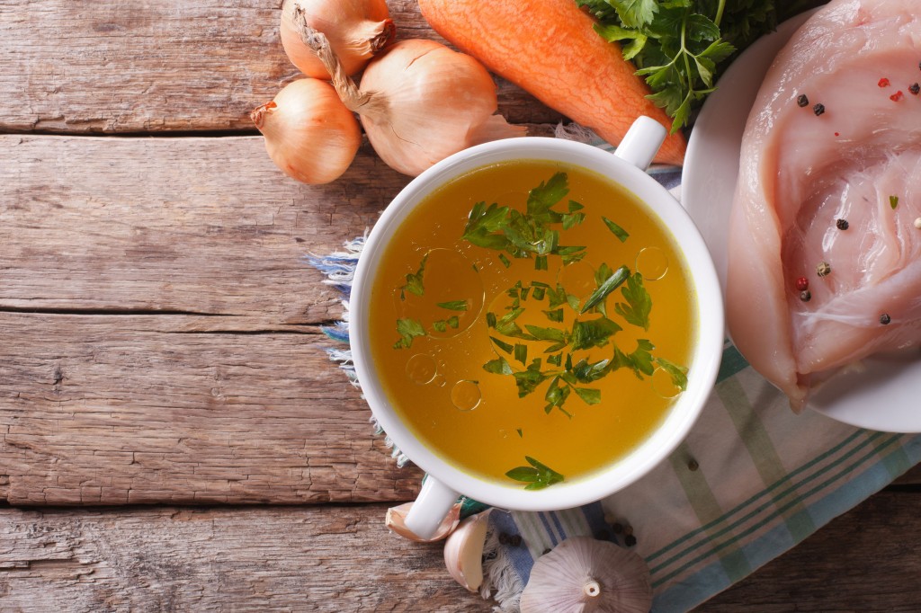 40235433 - country style: the chicken broth and the ingredients on the table