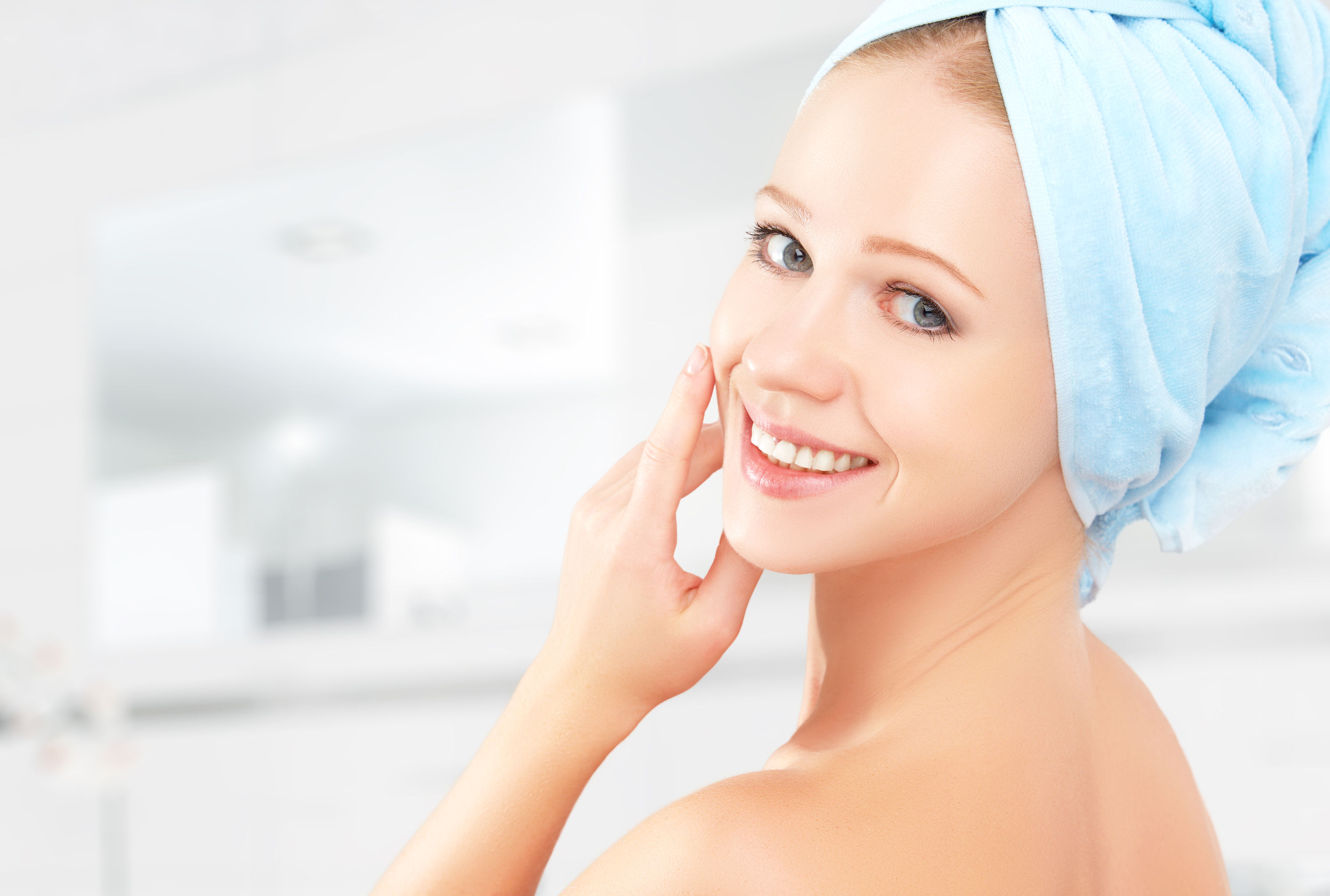 32696888 - skin care. young beautiful healthy girl in a towel in the bathroom