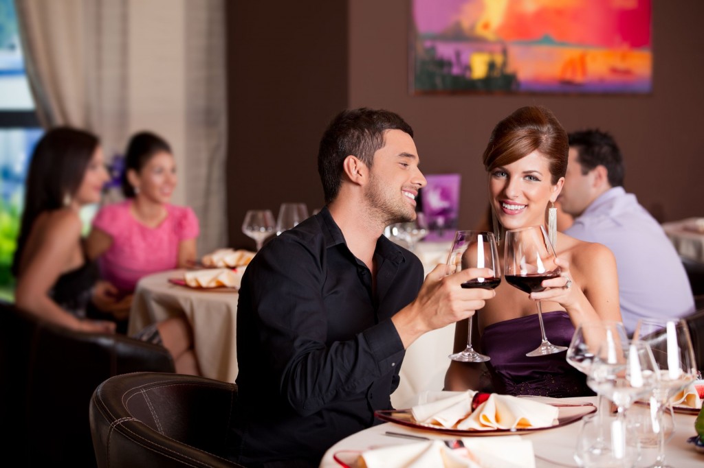 10297583 - romantic young couple at restaurant table toasting