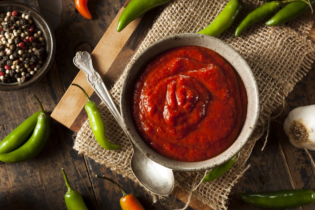 28569409 - hot spicy red sriracha sauce in a bowl