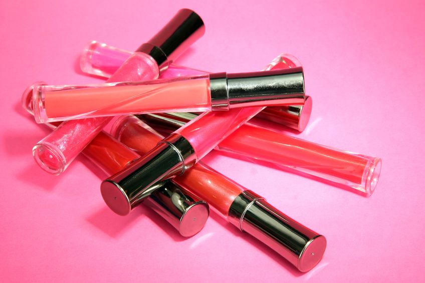18642296 - beautiful lip glosses, on pink background
